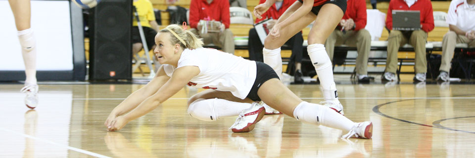 ISU volleyball player dives to catch the ball.