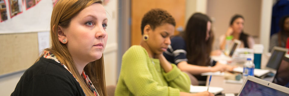 Students busily working on their laptops.