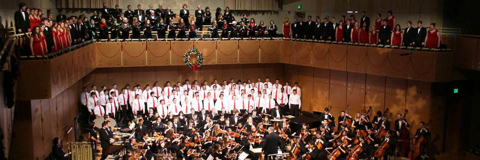 ISU choir and orchestra perform together in a large concert hall.