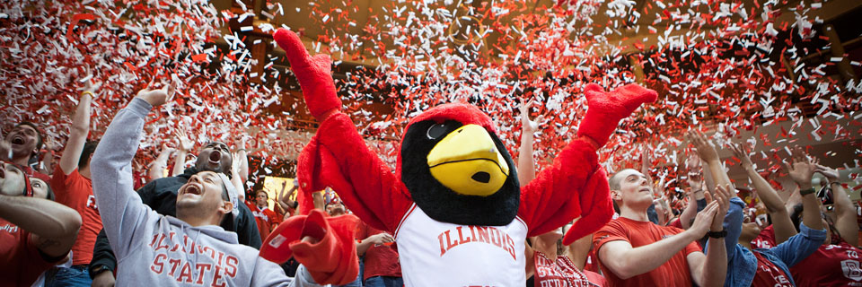 Students celebrating with Reggie Redbird as confetti falls to the ground.