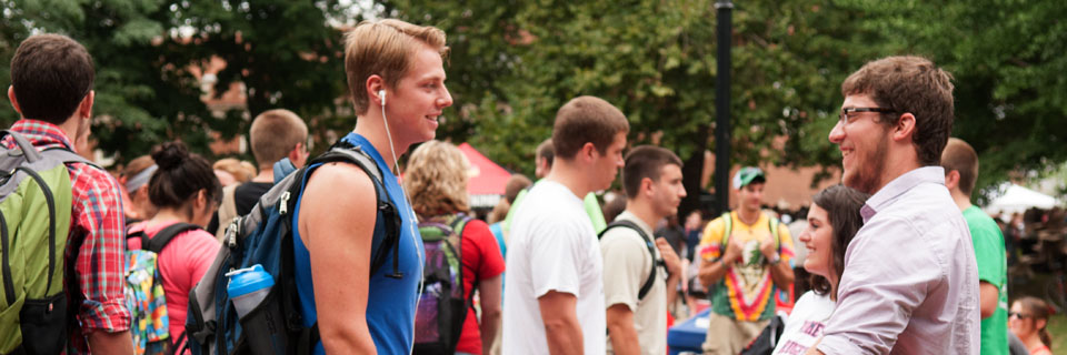 A student exploring the various campus clubs at Welcome Week.