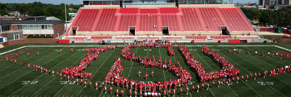 ISU students form the word 'ISU' with their bodies at Hancock Stadium.